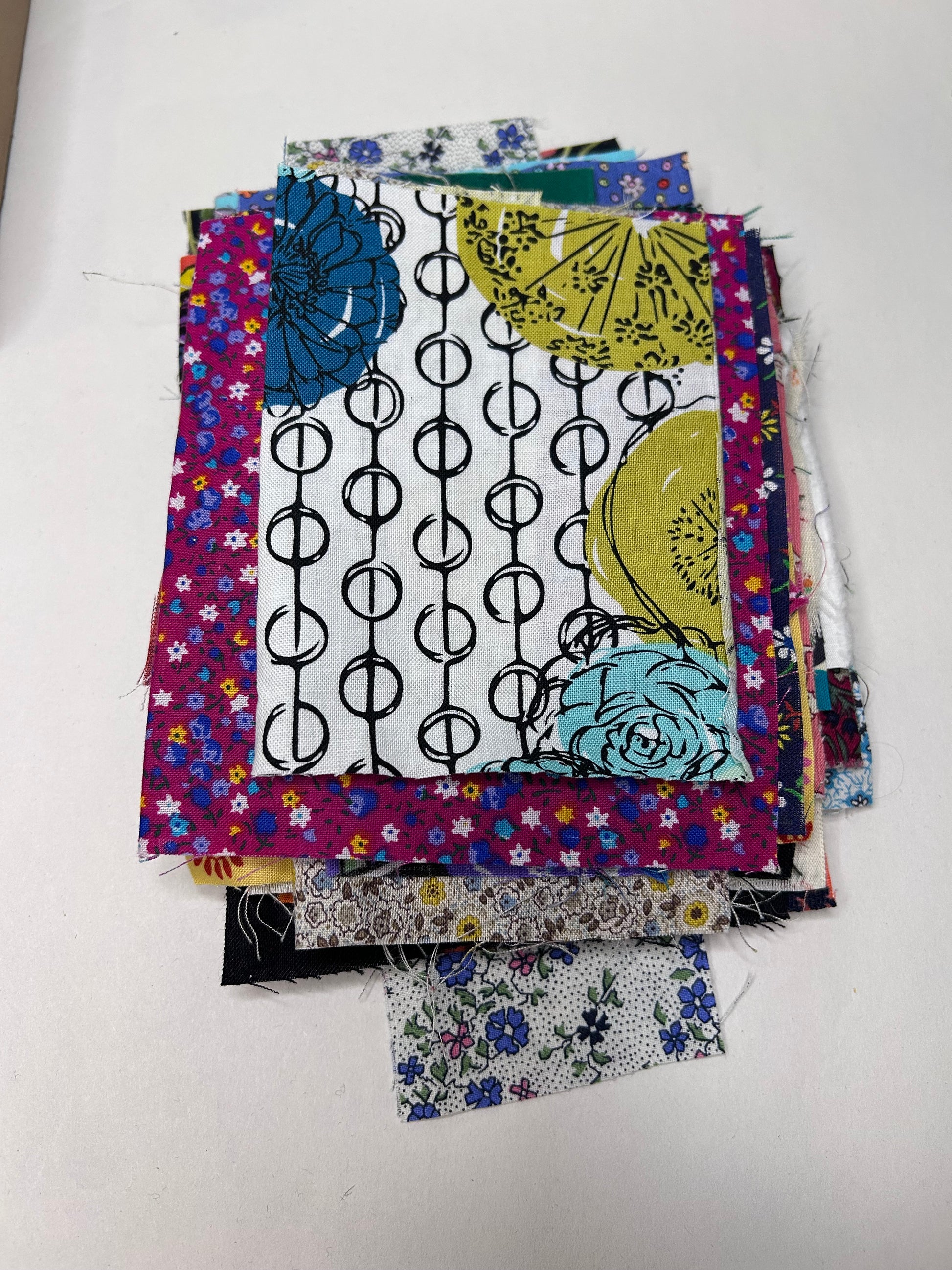 Collection of colorful fabric samples on a white background