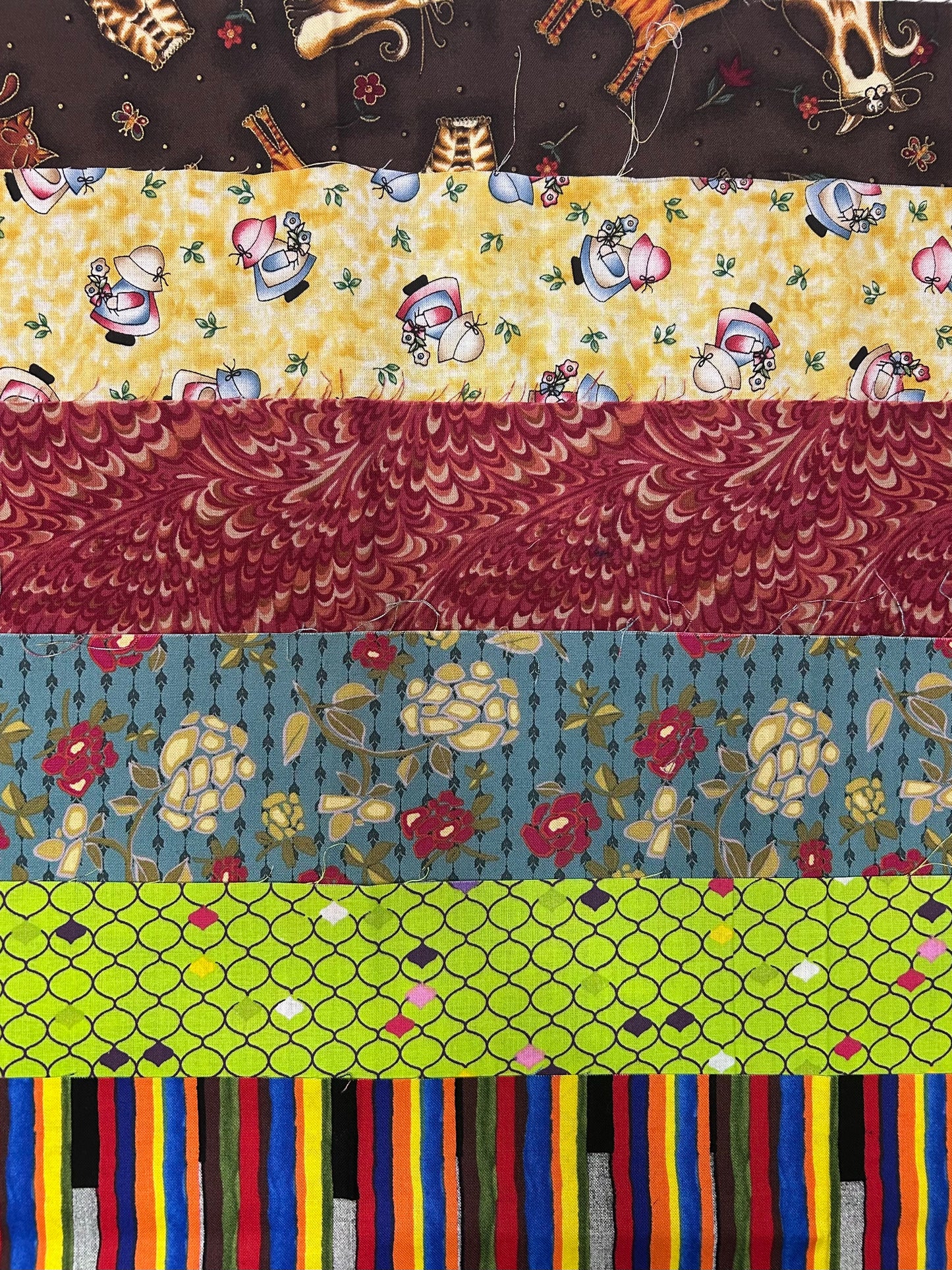 Collection of various patterned fabric strips arranged vertically subscription